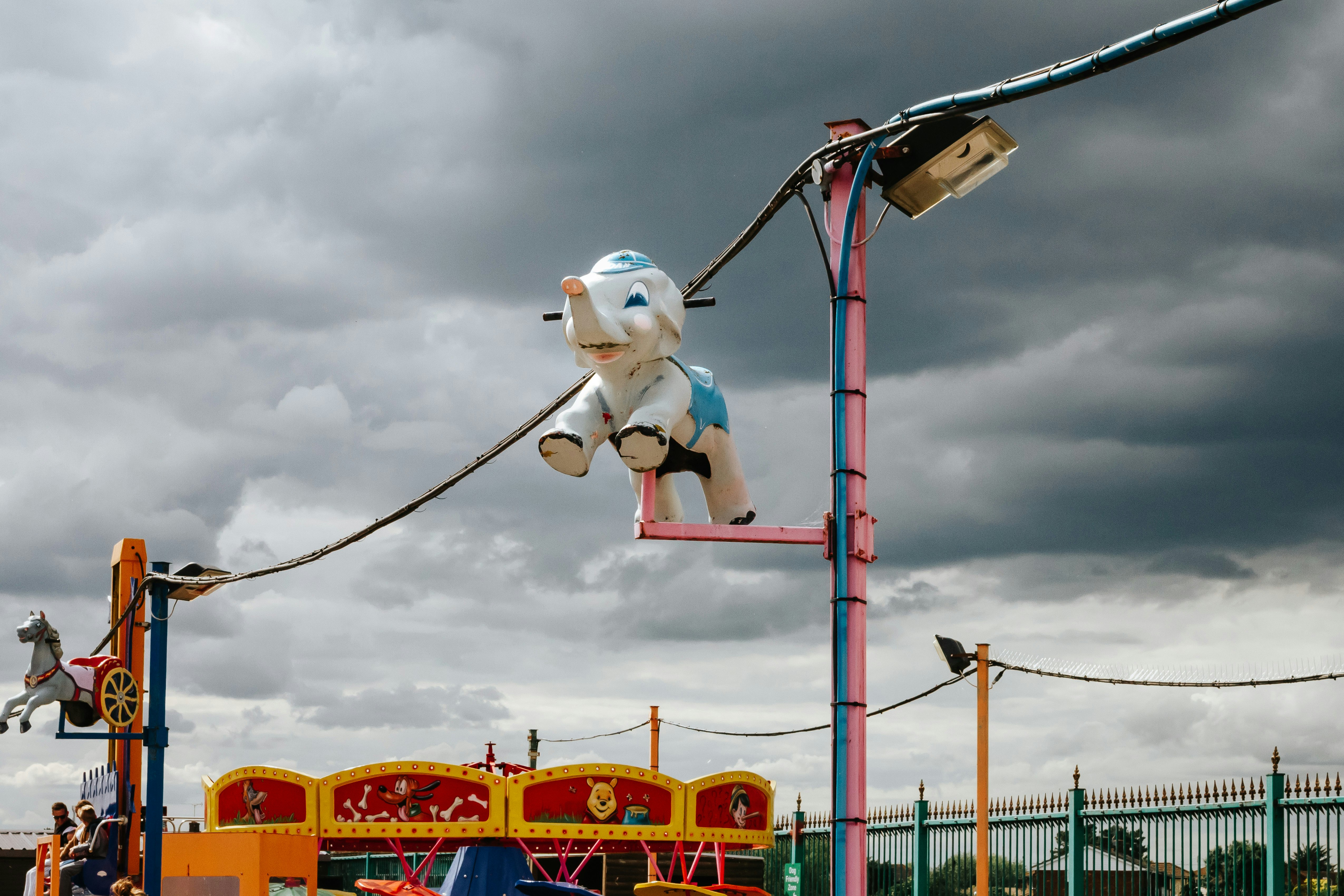 white and blue snowman riding on yellow and red roller coaster during daytime